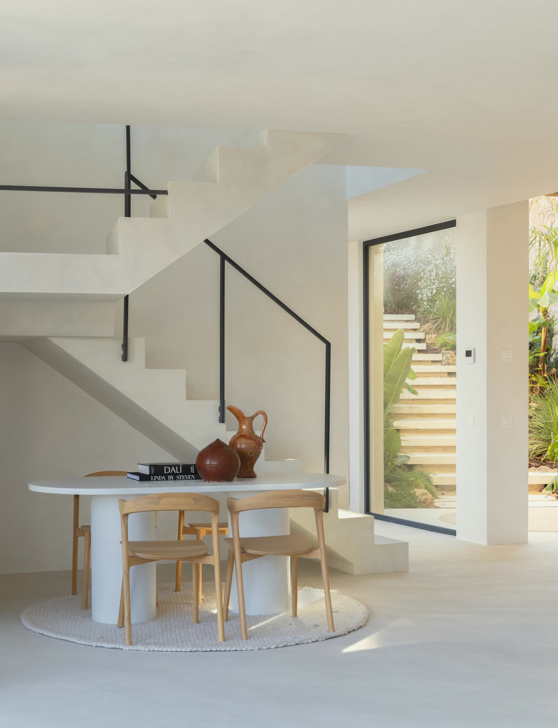 Dining table under the black-steel staircase